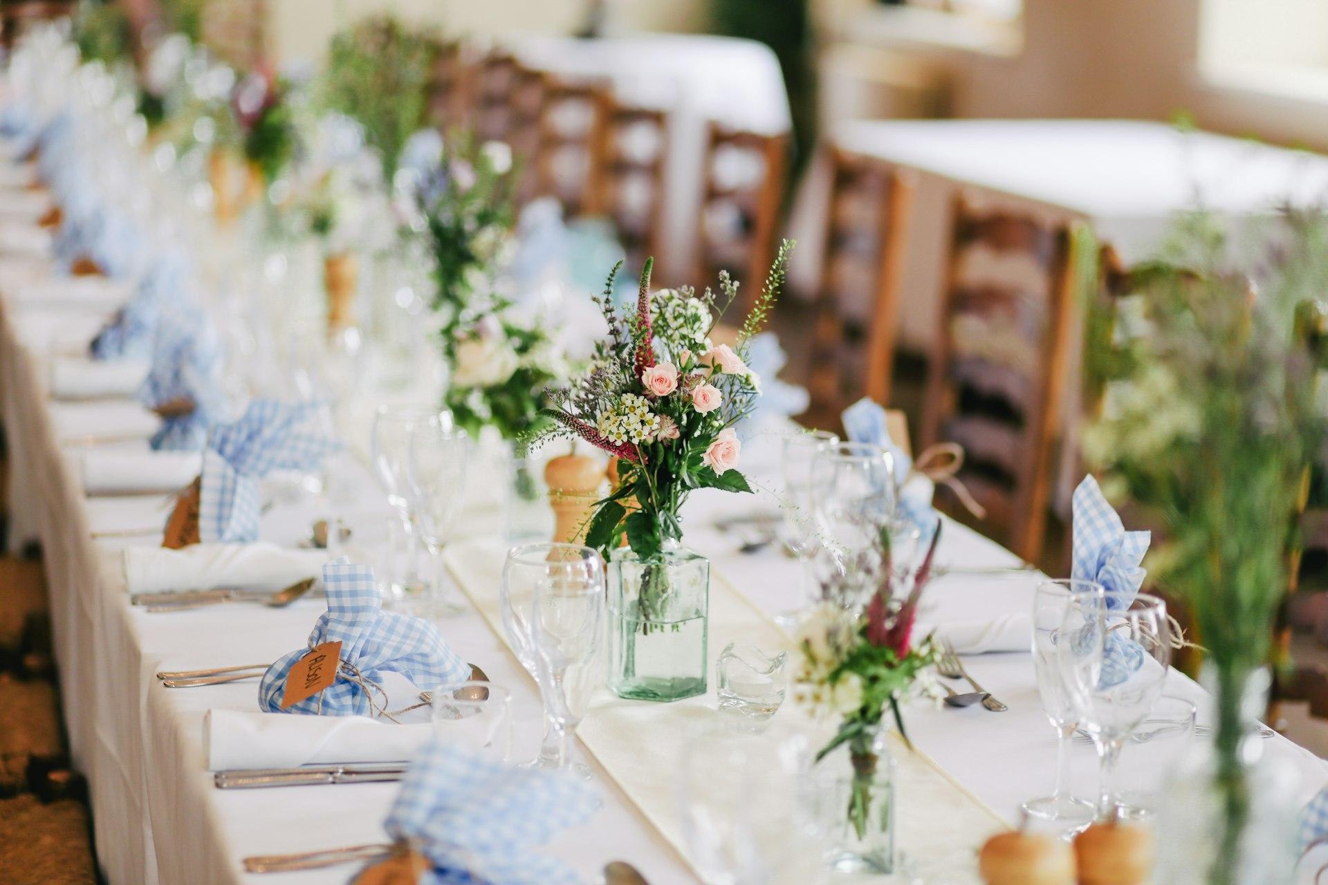 Placeholder: floral wedding tablescape with candles and greenery